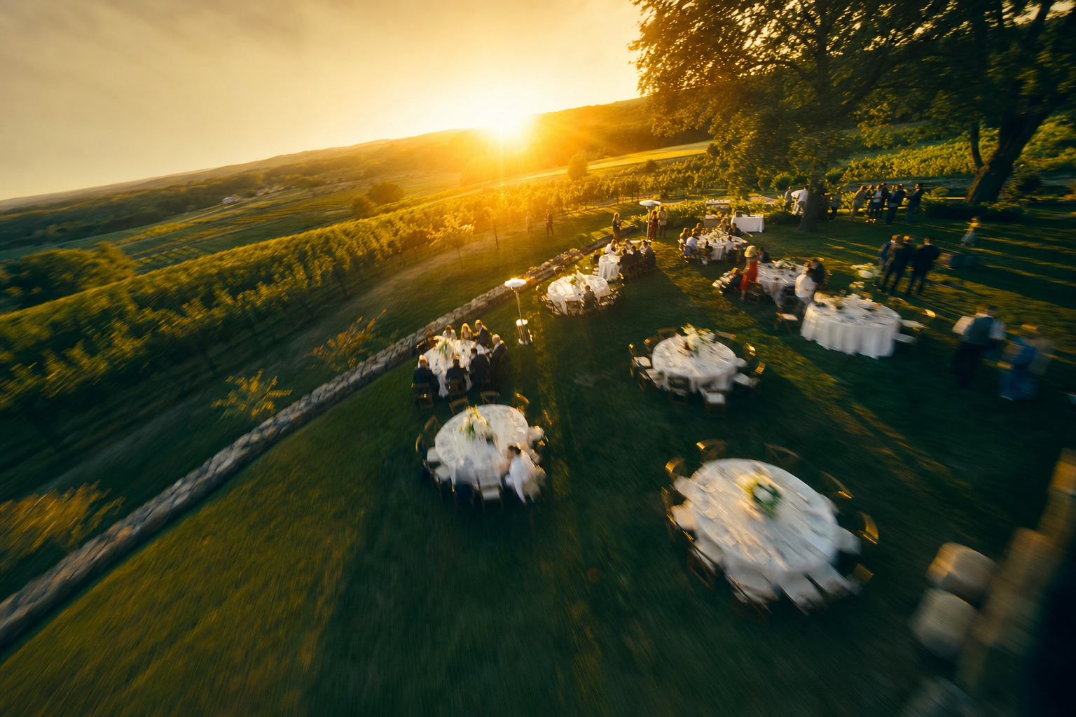 Low FPV drone pass over an outdoor reception at sunset